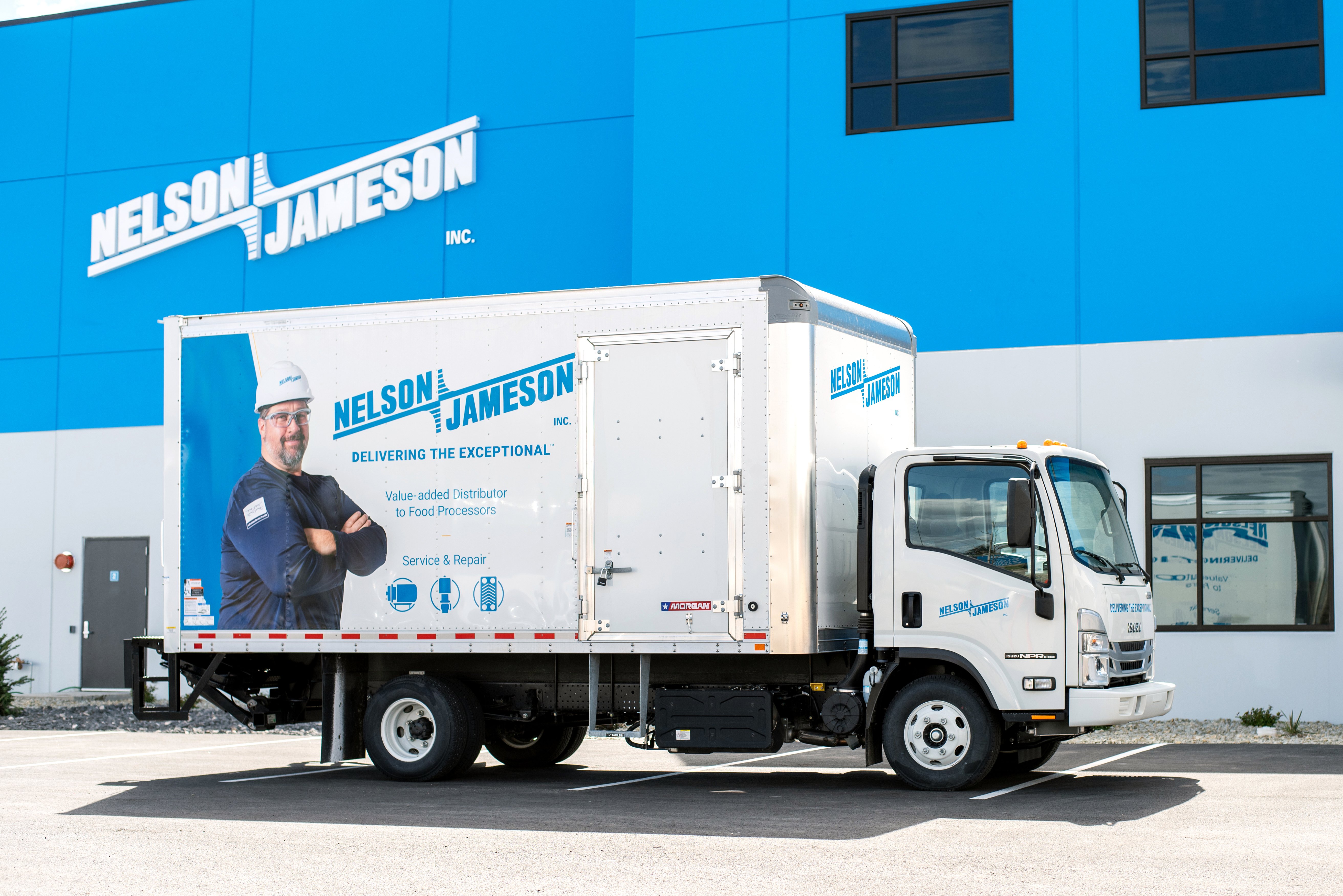 Nelson-Jameson-service-and-repair-box-truck-in-front-of-jerome-distribution-center-with-nj-logo